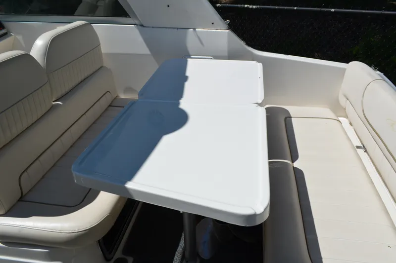 Slide: The Image of 2001 Monterey 282 Cruiser interior with white seating and table in sunlight. - 12