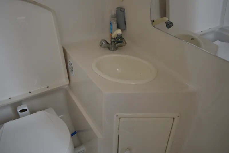 Slide: The Image of Bathroom interior of a 2001 Monterey 282 Cruiser boat, featuring a sink and toilet. - 35