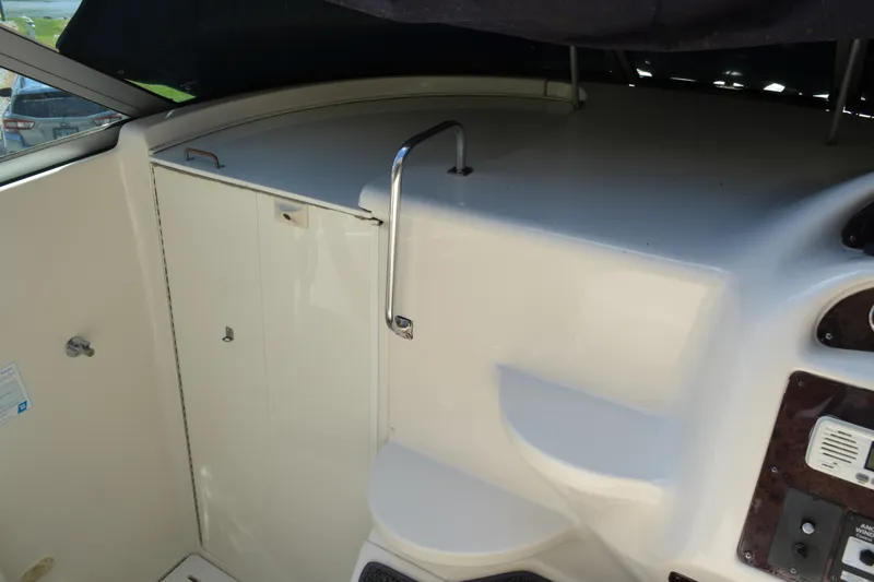 Slide: The Image of Interior view of a 2001 Monterey 282 Cruiser boat, featuring a sleek white cabin area. - 16