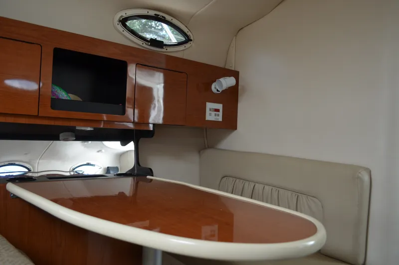 Slide: The Image of Interior of 2001 Monterey 282 Cruiser with wooden cabinetry and seating area. - 28