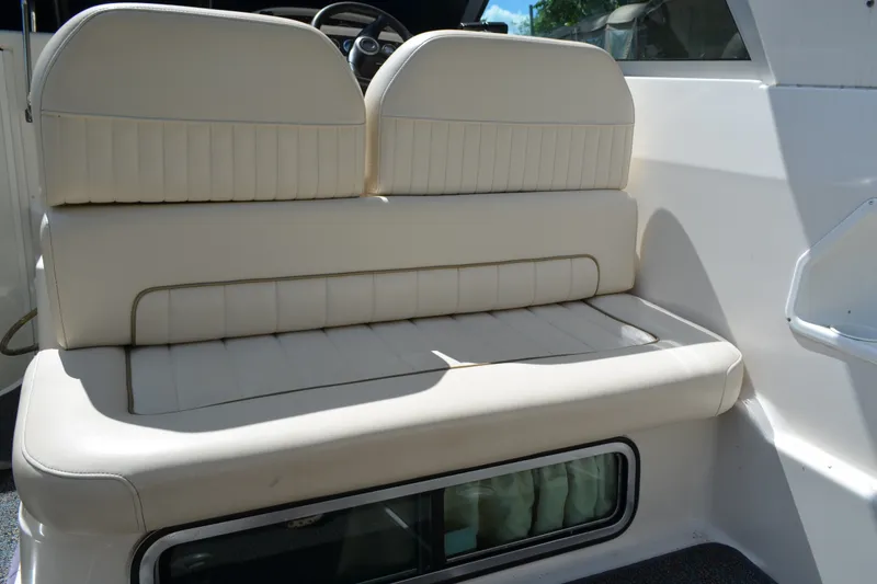 Slide: The Image of Cream leather seating on a 2001 Monterey 282 Cruiser boat interior. - 10