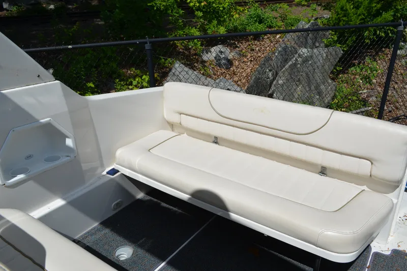 Slide: The Image of 2001 Monterey 282 Cruiser boat interior with white seating and cup holders. - 8