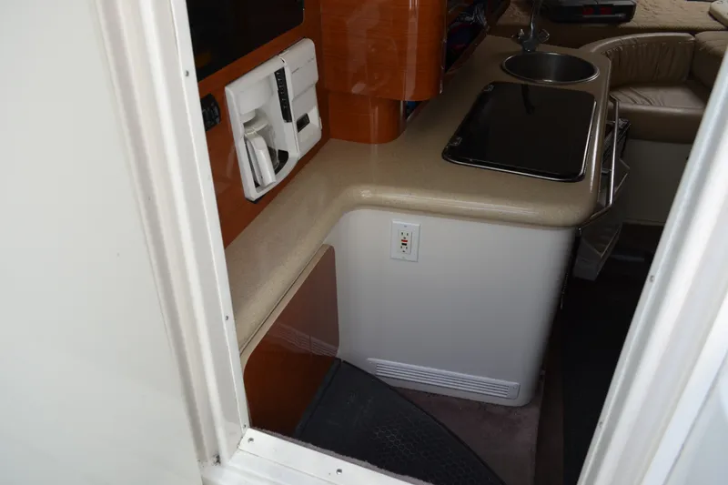 Slide: The Image of Interior view of a 2001 Monterey 282 Cruiser, featuring a compact kitchenette. - 17