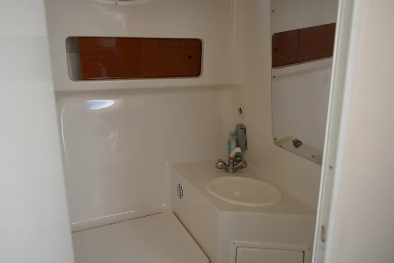 Slide: The Image of Interior of a 2001 Monterey 282 Cruiser boat bathroom with sink and storage. - 34
