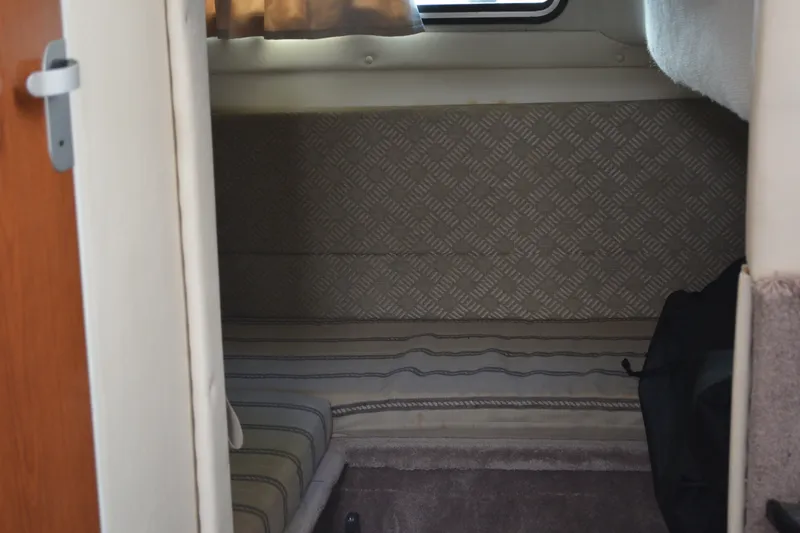 Slide: The Image of Interior cabin of a 2001 Monterey 282 Cruiser with patterned upholstery and a small window. - 30