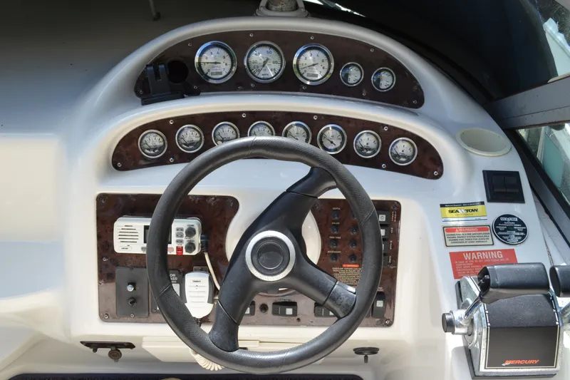 Slide: The Image of Steering wheel and dashboard of a 2001 Monterey 282 Cruiser boat, featuring gauges and controls. - 15