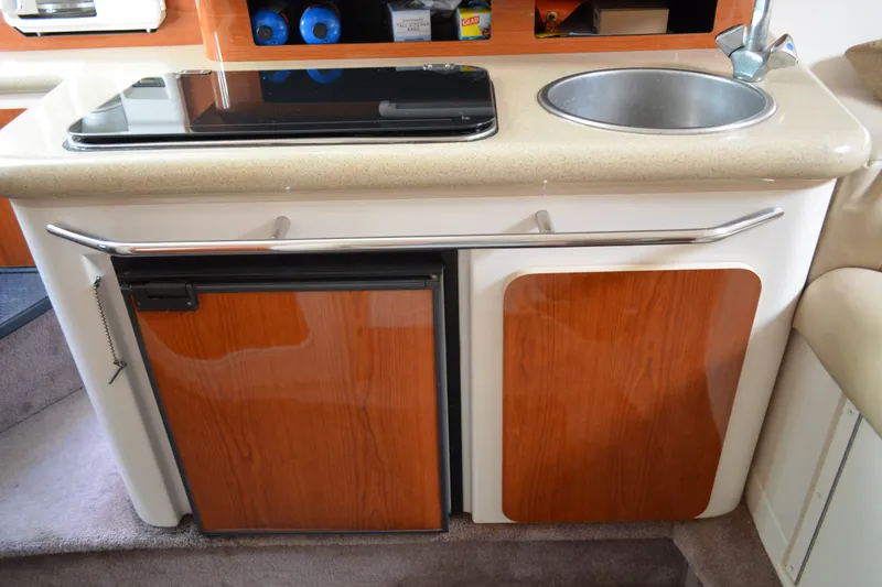 Slide: The Image of Compact kitchenette in a 2001 Monterey 282 Cruiser with sink, stove, and storage. - 21
