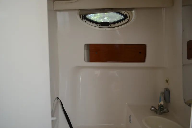 Slide: The Image of Interior of 2001 Monterey 282 Cruiser boat bathroom with sink and porthole window. - 33