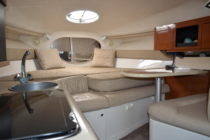 Slide: The Image of Interior of a 2001 Monterey 282 Cruiser boat with cozy seating and kitchenette. - 18