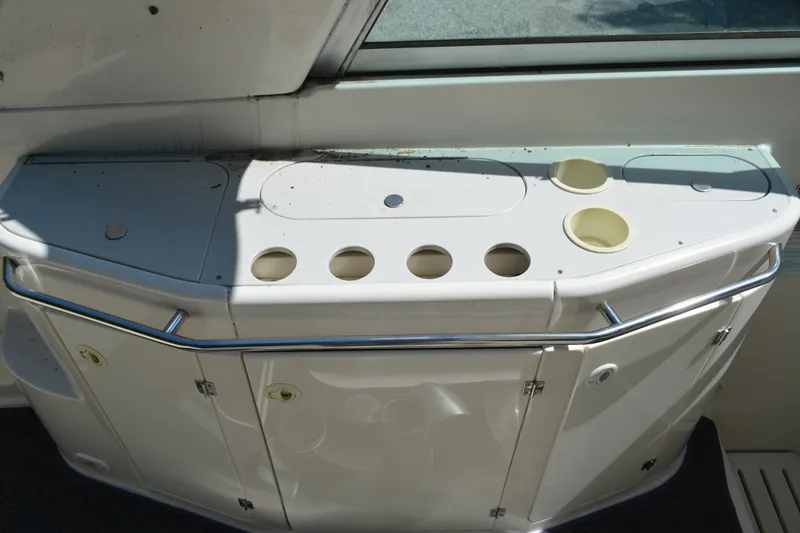 Slide: The Image of 2001 Monterey 282 Cruiser boat interior with cup holders and storage compartments. - 13