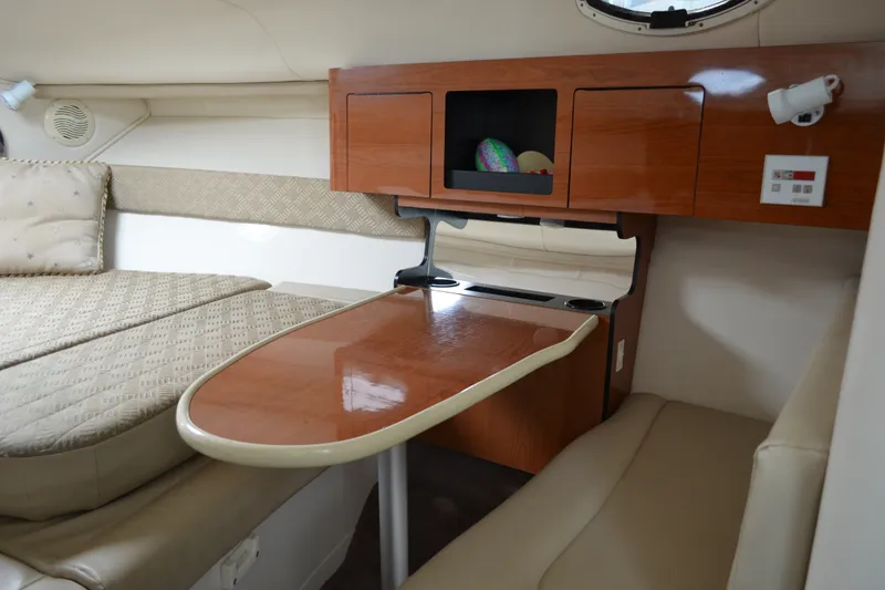 Slide: The Image of Interior of 2001 Monterey 282 Cruiser with wooden table and cushioned seating. - 19