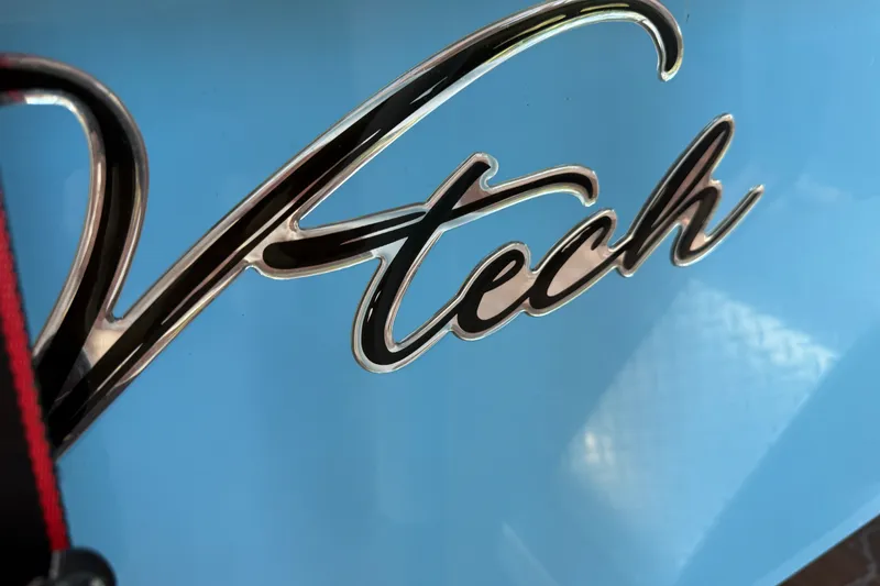 Slide: The Image of Chrome "V-tech" logo on a blue 2025 V-tech model 18 vehicle. - 20