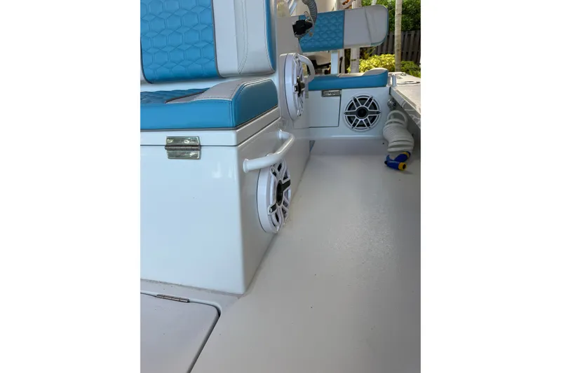 Slide: The Image of Interior of a 2025 V-Tech 18 boat with blue seating and speakers. - 16