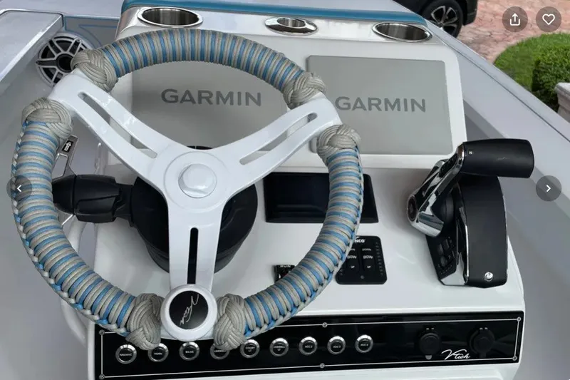 Slide: The Image of Steering console of 2025 V-Tech 18 boat with Garmin displays and wrapped wheel. - 24