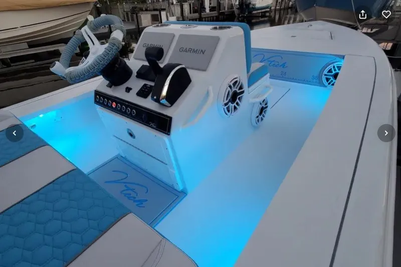 Slide: The Image of 2025 V-Tech 18 boat interior with blue LED lighting and Garmin navigation system. - 22