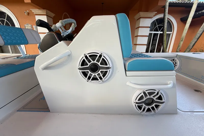 Slide: The Image of Boat interior with blue seating and speakers, V-Tech model 18, year 2025. - 8