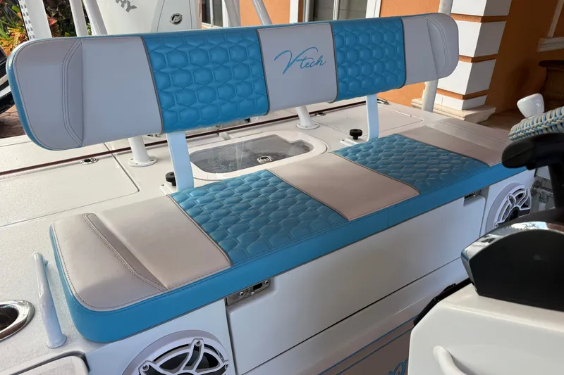 Slide: The Image of Blue and white V-Tech 18 boat seat, 2025 model, with hexagonal pattern design. - 5
