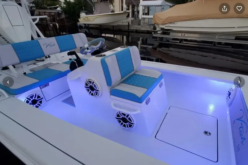 Slide: The Image of Modern V-Tech 18 boat interior with blue LED lighting, 2025 model. - 21