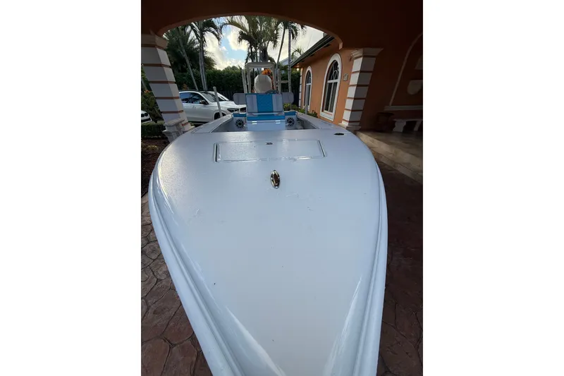 Slide: The Image of 2025 V-Tech 18 boat parked under a canopy near a house. - 3