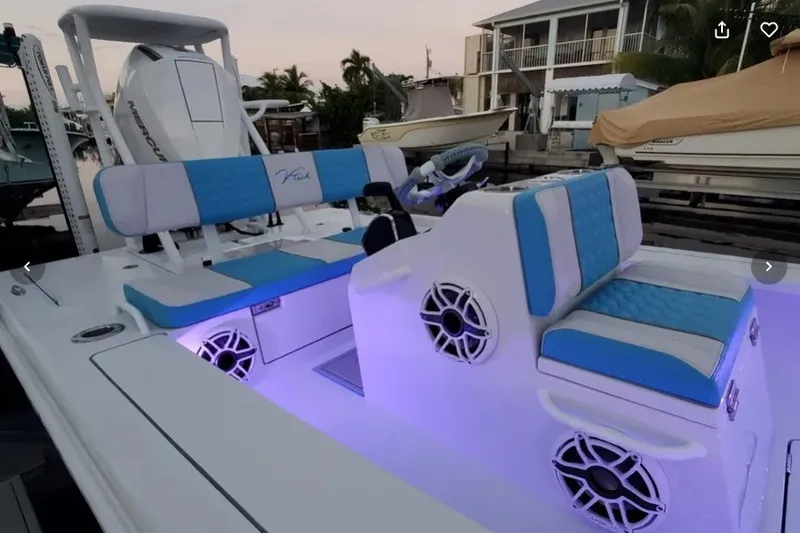 Slide: The Image of Modern V-Tech 18 boat interior with blue seating and ambient lighting, 2025 model. - 23