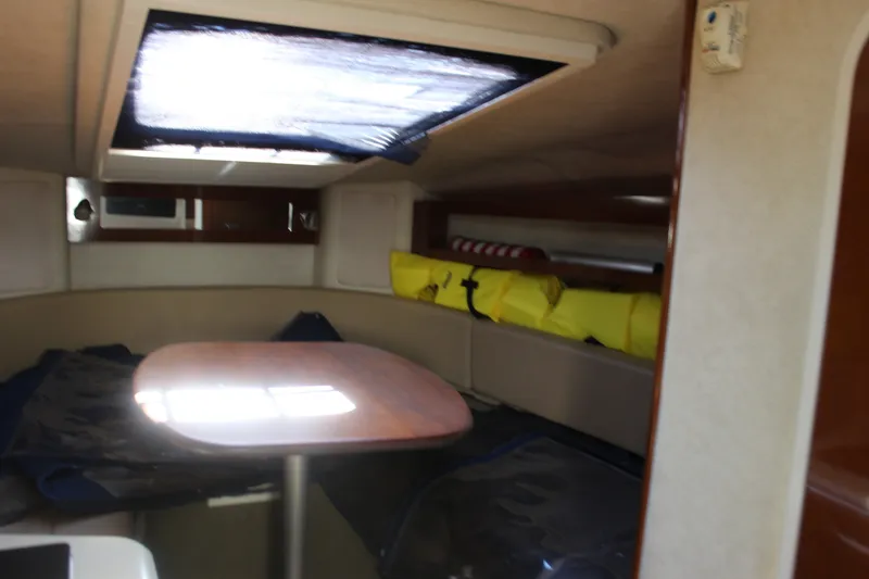 Slide: The Image of Interior cabin of 2012 Sea Ray Sundancer 280 with table and seating area. - 27