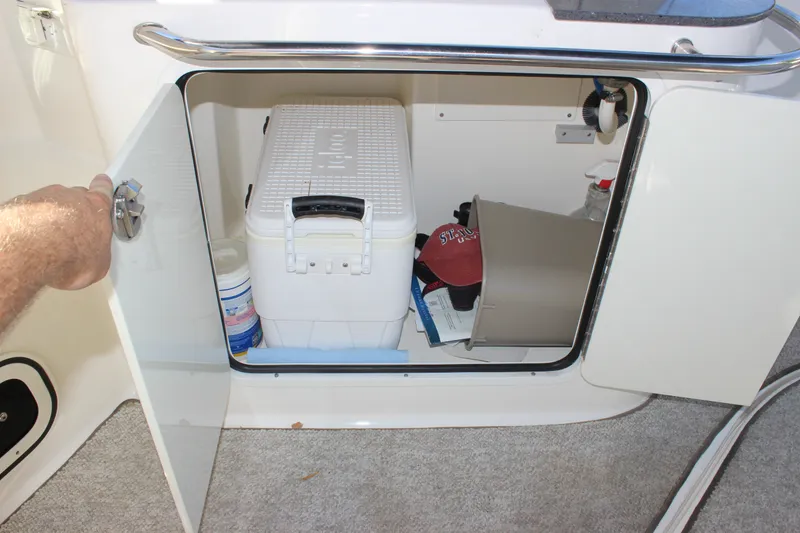 Slide: The Image of Storage compartment on a 2012 Sea Ray Sundancer 280 with cooler and accessories. - 16