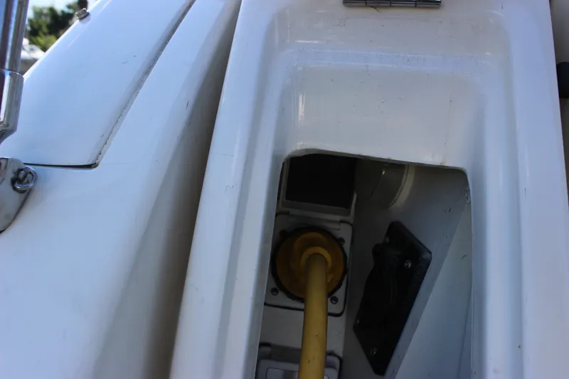 Slide: The Image of Close-up of a 2012 Sea Ray Sundancer 280 boat compartment with a yellow hose. - 22