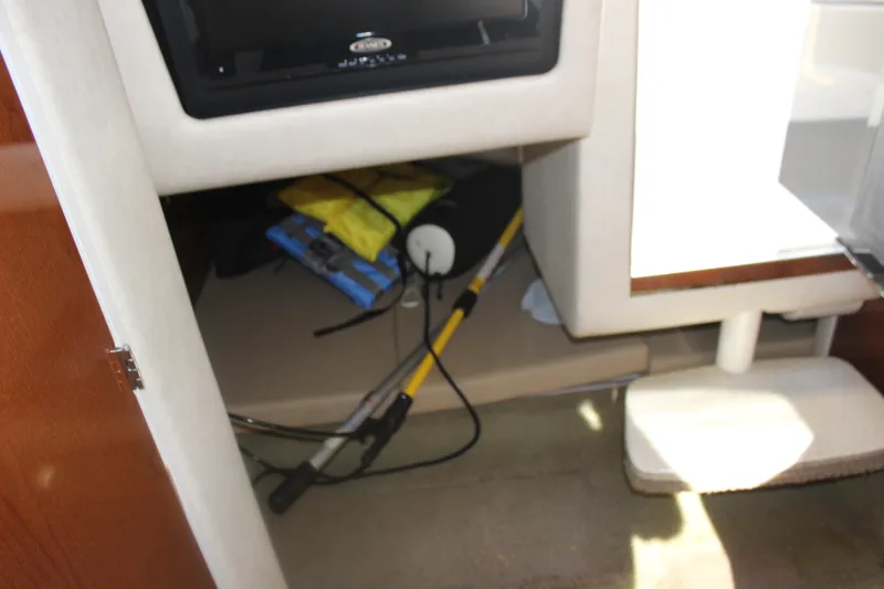Slide: The Image of Interior storage area of 2012 Sea Ray Sundancer 280 boat with equipment and supplies. - 31