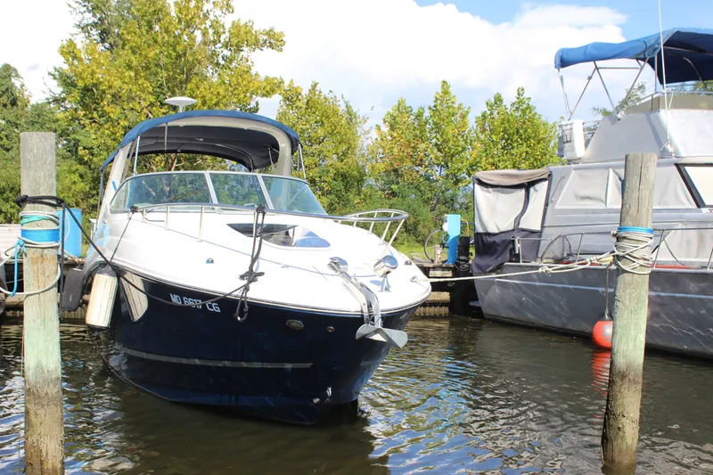 Slide: The Image of 2012 Sea Ray Sundancer 280 docked at marina, surrounded by trees and water. - 5