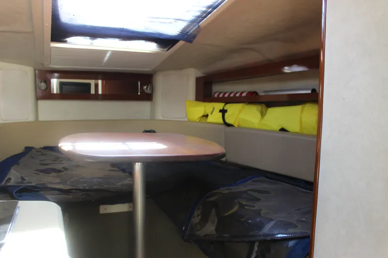 Slide: The Image of Interior cabin of 2012 Sea Ray Sundancer 280 with table and seating area. - 28