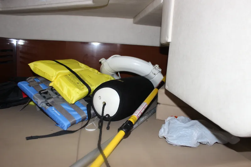 Slide: The Image of Safety equipment stored inside a 2012 Sea Ray Sundancer 280 boat cabin. - 35