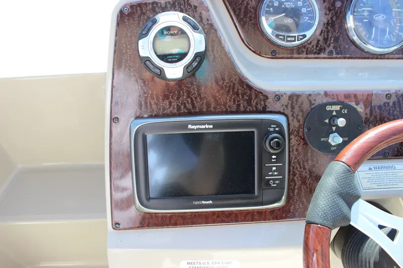 Slide: The Image of Dashboard of 2012 Sea Ray Sundancer 280 with Raymarine display and Sony audio controls. - 17