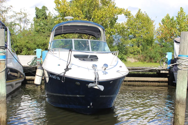 Slide: The Image of 2012 Sea Ray Sundancer 280 docked, surrounded by lush greenery and calm waters. - 4