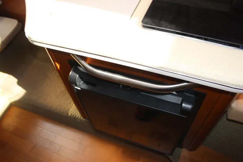 Slide: The Image of Interior view of a 2012 Sea Ray Sundancer 280, featuring a compact kitchenette. - 30