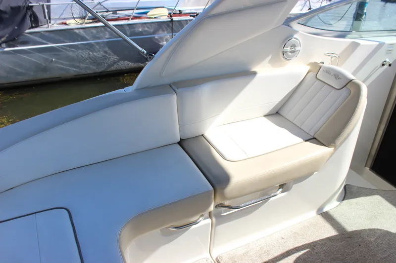 Slide: The Image of 2012 Sea Ray Sundancer 280 interior seating with beige and white upholstery. - 11