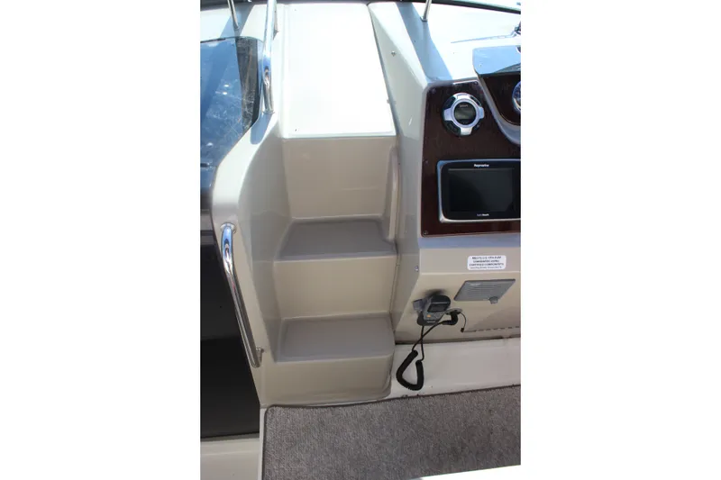 Slide: The Image of Helm station of 2012 Sea Ray Sundancer 280 with steps and navigation equipment. - 24