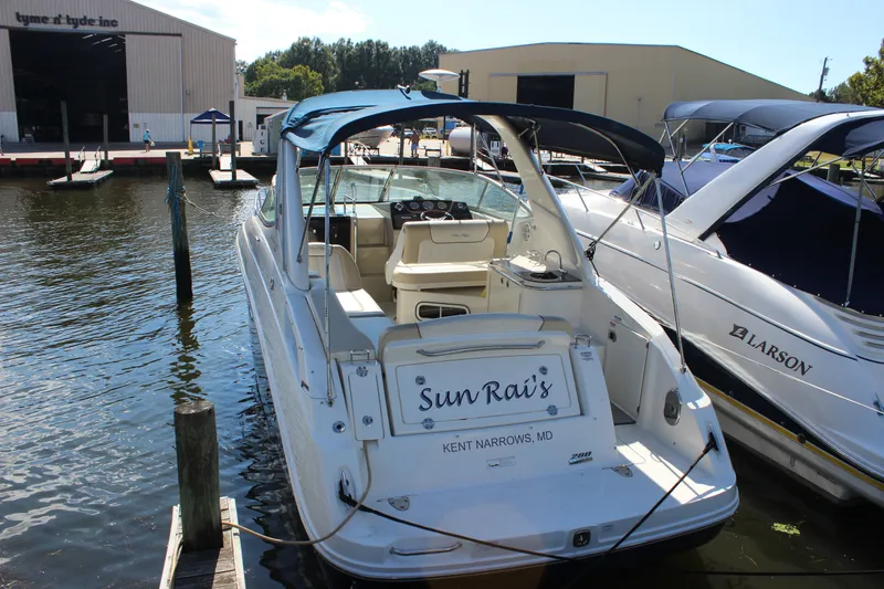 Slide: The Image of 2012 Sea Ray Sundancer 280 docked at marina, featuring spacious cockpit and canopy. - 7