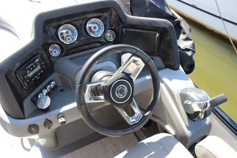 Slide: The Image of Steering console of 2020 Avalon Catalina Platinum Cruise Funship boat with gauges and controls. - 16