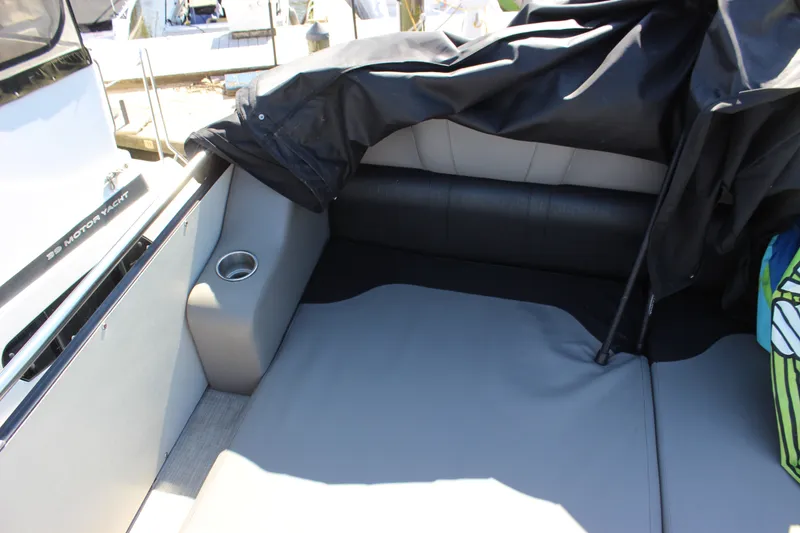 Slide: The Image of Interior seating of 2020 Avalon Catalina Platinum Cruise Funship, featuring gray upholstery and cup holder. - 32