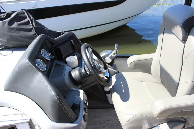Slide: The Image of Steering console of 2020 Avalon Catalina Platinum Cruise Funship, featuring gauges and comfortable seating. - 15