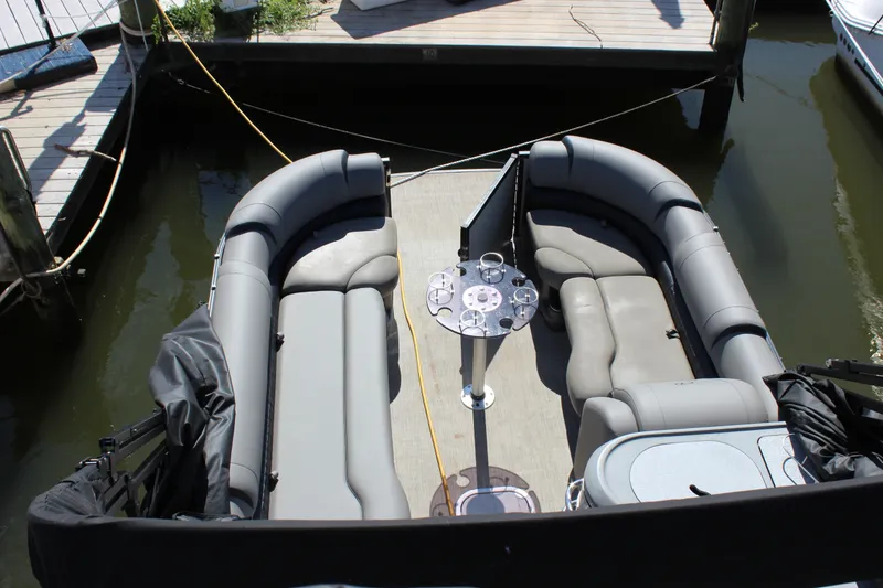 Slide: The Image of 2020 Avalon Catalina Platinum Cruise Funship boat interior with gray seating and table. - 27