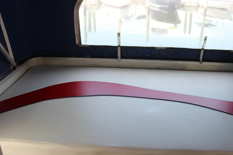 Slide: The Image of Interior view of a 1994 Sun Tracker Party Cruiser 32 Regency Edition with a red accent. - 20