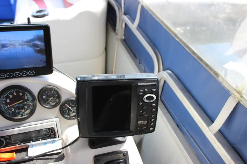 Slide: The Image of Dashboard of a 1994 Sun Tracker Party Cruiser 32 Regency Edition with navigation equipment. - 24