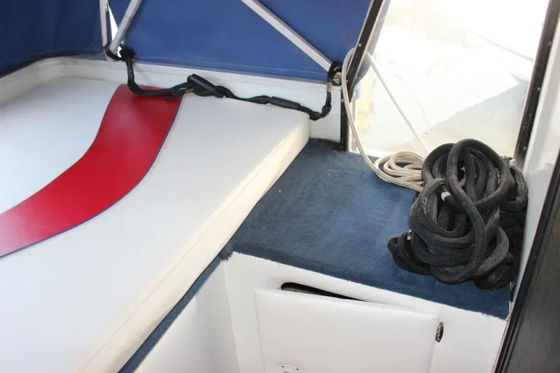 Slide: The Image of Interior of 1994 Sun Tracker Party Cruiser 32 with seating and coiled rope. - 22