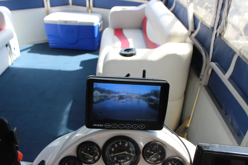 Slide: The Image of Interior of 1994 Sun Tracker Party Cruiser with navigation screen and seating area. - 23