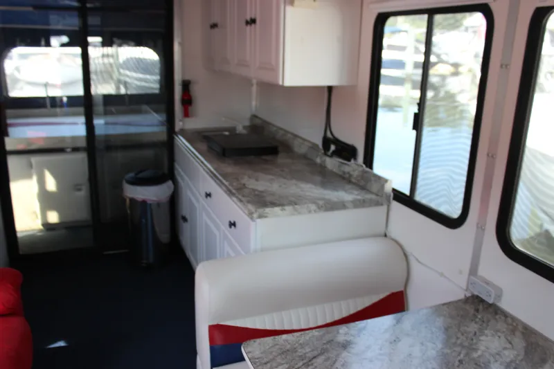 Slide: The Image of Interior of 1994 Sun Tracker Party Cruiser 32 Regency Edition with kitchenette and seating area. - 15