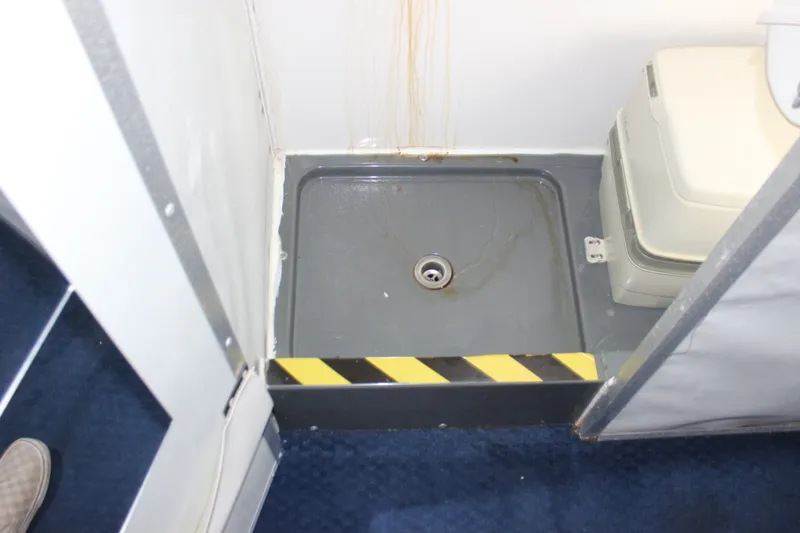 Slide: The Image of Interior of 1994 Sun Tracker Party Cruiser 32 Regency Edition, featuring a compact shower area. - 19