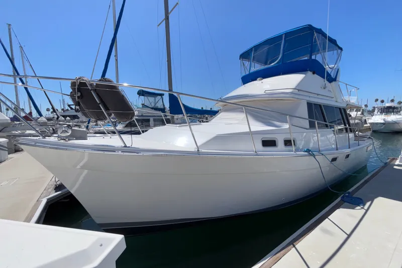 The Image of 1989 Bayliner 3288 Motoryacht docked at marina under clear blue sky. - 1