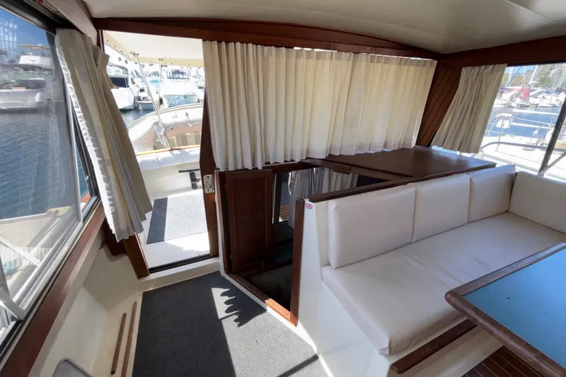 Slide: The Image of Interior of 1989 Bayliner 3288 Motoryacht with seating and marina view. - 18