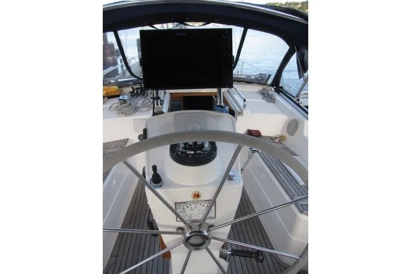Slide: The Image of Cockpit of 2002 Nauticat 37 sailboat with steering wheel and navigation equipment. - 27